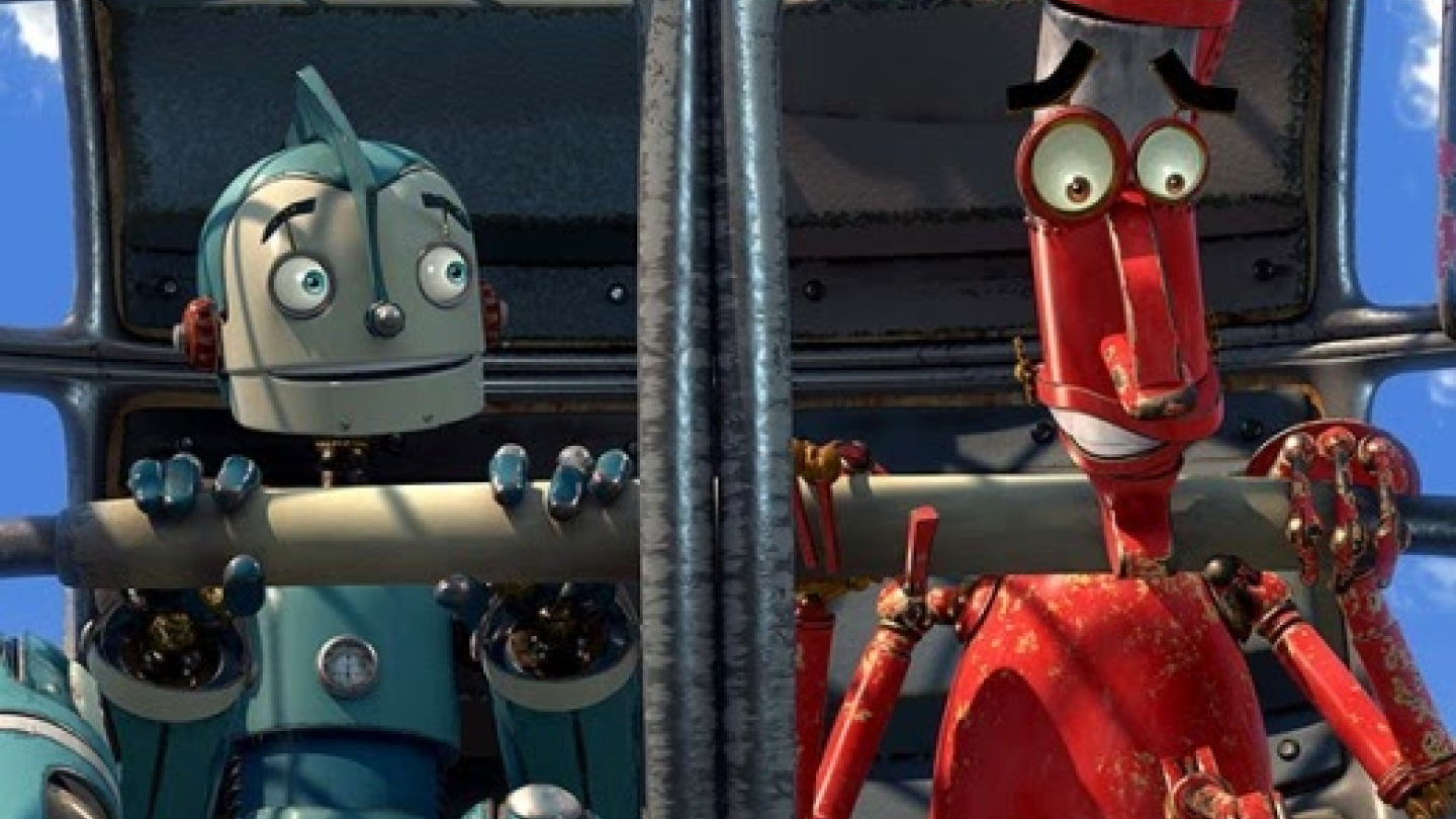Os personagens Rodney e Manivela, da animação "Robôs", aparecem lado a lado dentro de uma estrutura metálica com expressões de surpresa e apreensão