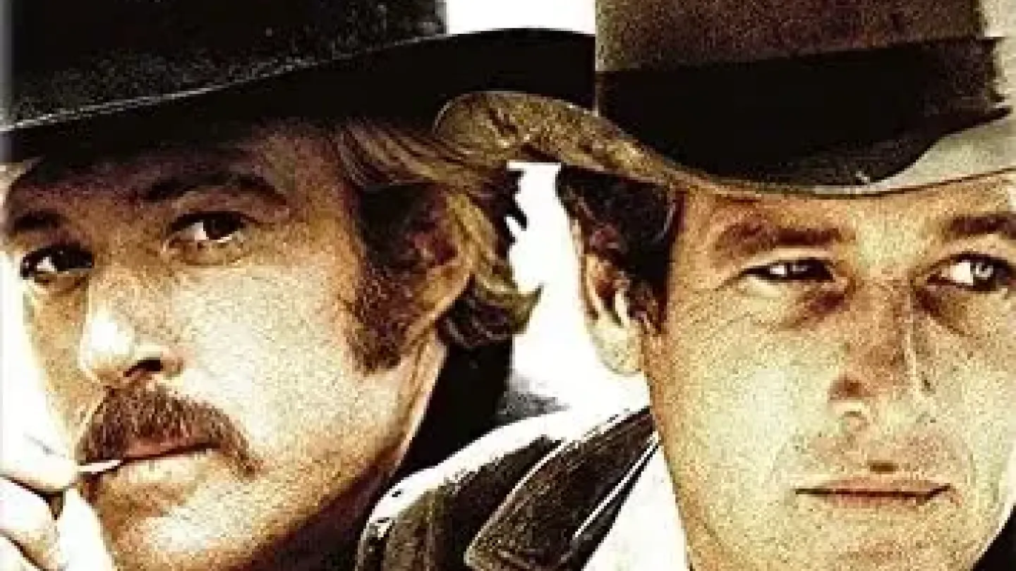 Cartaz do filme Butch Cassidy and the Sundance Kid. Em primeiro plano, aparecem os rostos de dois homens usando chapéus de caubói e roupas típicas do Velho Oeste. Um deles segura um cigarro entre os dedos. Na parte inferior, o título do filme está em destaque, acompanhado dos nomes dos atores Paul Newman e Robert Redford.